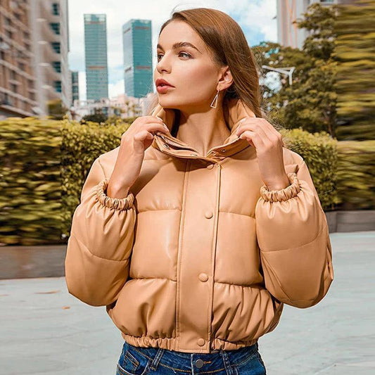 Mandotos chic winter PU leather jacket displayed on a hanger, featuring a stylish design and smooth black leather texture.