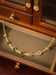 Vintage 14K gold choker necklace by MANDOTOS featuring a classic, elegant design with a smooth, polished finish.