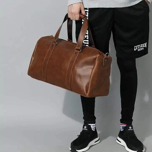 Mandotos classic leather duffel bag with sturdy handles and spacious interior, ideal for travel and weekend trips.