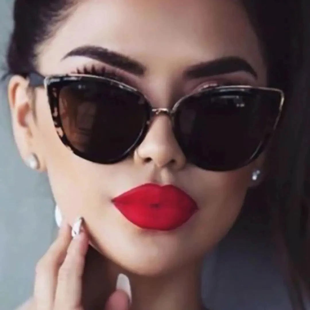 Mandotos Cleo Cat Eye Shades with black frames and tinted lenses, stylish eyewear for a chic, vintage-inspired look.