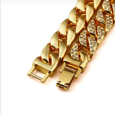 Mandotos Clyde Elegance gold bracelet with intricate design and polished finish on a white background