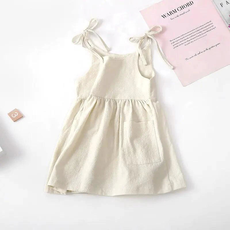 Toddler girl wearing a light blue cotton sundress with floral design from MANDOTOS, perfect for warm-weather wear.