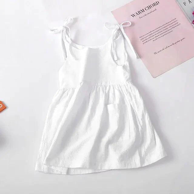 Toddler wearing a light cotton sundress with floral pattern, pink and white, from MANDOTOS, perfect for warm weather.