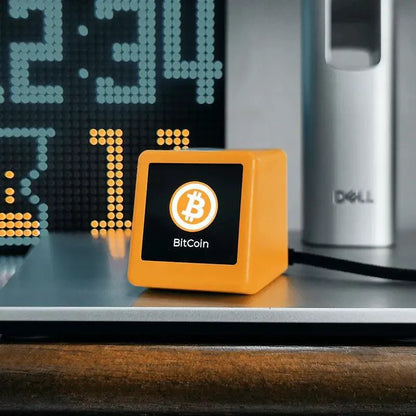 Mandotos Crypto Desk Tracker displaying a digital cryptocurrency tracking device on a workspace.