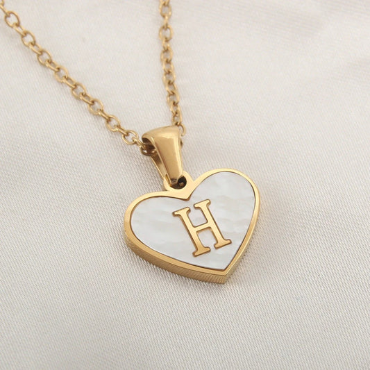 Mandotos 26-letter heart-shaped necklace with white shell accents, personalized love pendant on a delicate clavicle chain for women.