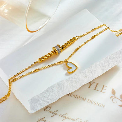 Mandotos boho love heart ankle chain with double-layer chain, charm, tassel, and foot chain design for women's party jewelry accessories.