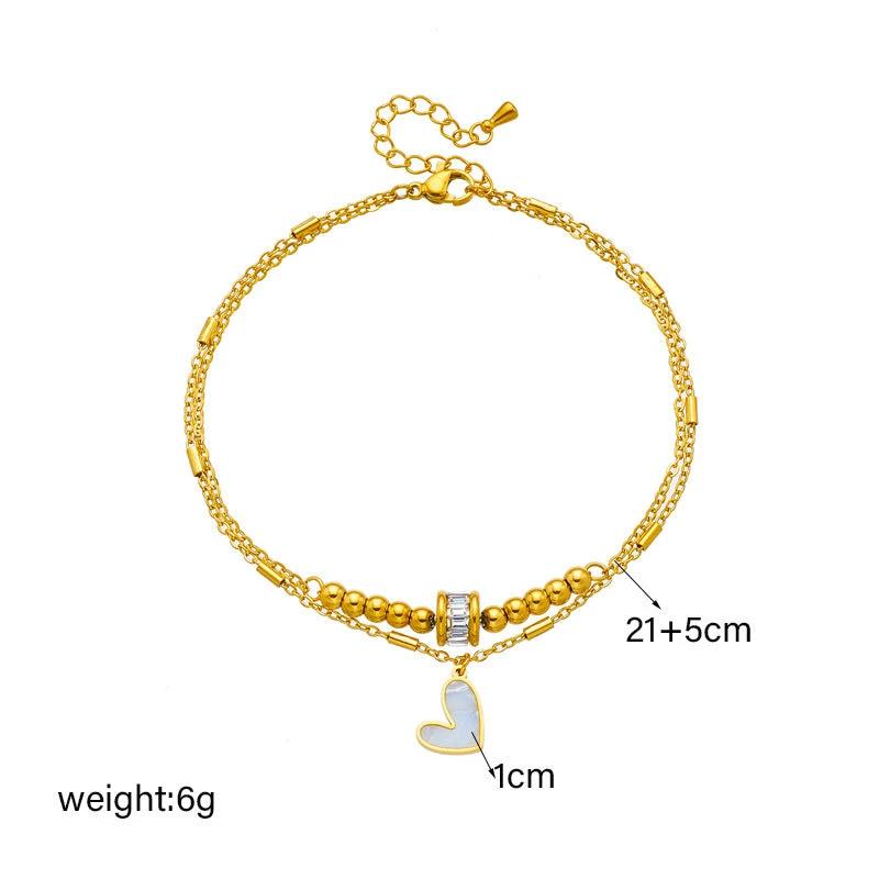 Mandotos boho love heart ankle chain with double layers, charm tassels, and leg chain design for women’s jewelry and party accessories.
