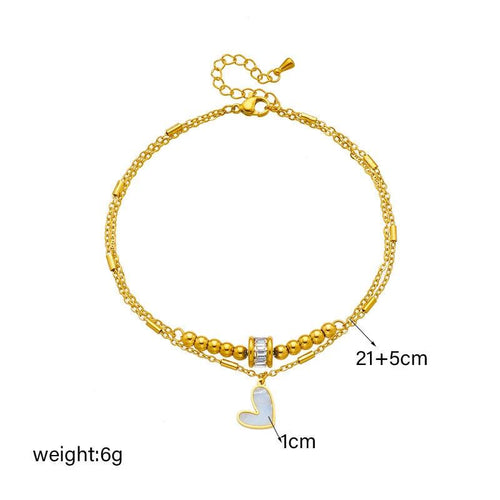 Mandotos boho love heart ankle chain with double layers, charm tassels, and leg chain design for women’s jewelry and party accessories.