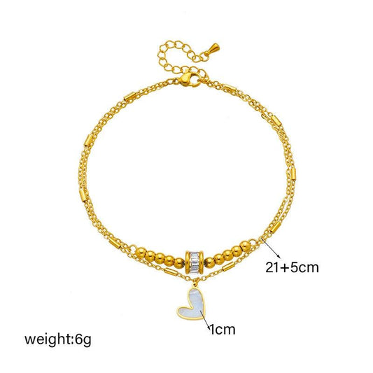 Mandotos boho love heart ankle chain with double layers, charm tassels, and leg chain design for women’s jewelry and party accessories.