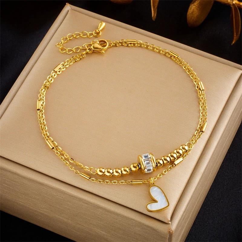 Mandotos boho fashion jewelry featuring a double layer love heart ankle chain with tassels and charms, ideal for women’s party accessories.