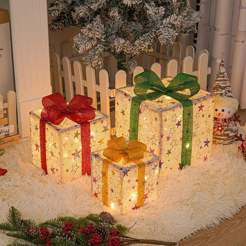 Lighted Christmas gift box decoration by MANDOTOS, luminous outdoor ornament with a festive bow and glowing lights.