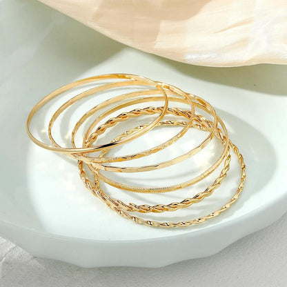 Six-piece MANDOTOS Bohemian metal chain bracelet set for women featuring geometric gold-colored thick link bangles.