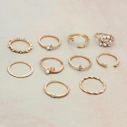 Mandotos Bohemian star, moon, pearl, and leaf rings in a 10-piece gold-finish stackable ring set, featuring intricate designs.
