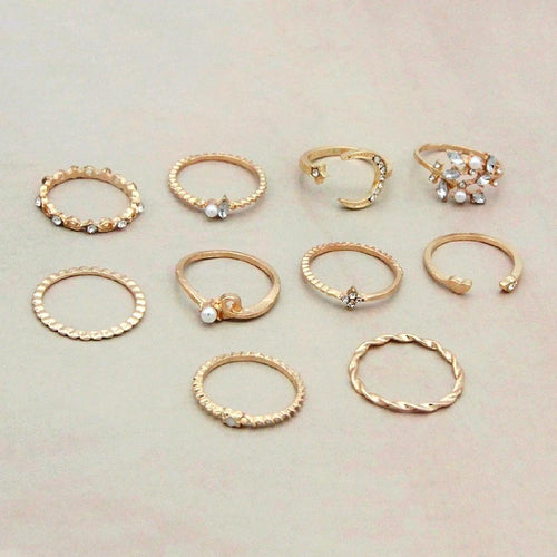 Mandotos Bohemian star, moon, pearl, and leaf rings in a 10-piece gold-finish stackable ring set, featuring intricate designs.