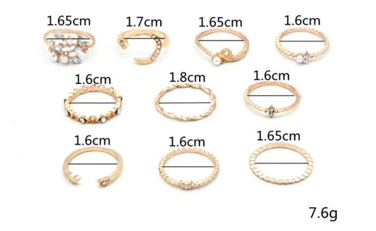 Mandotos Bohemian star, moon, pearl, and leaf ring set with gold finish, featuring 10 stackable rings on a white background.