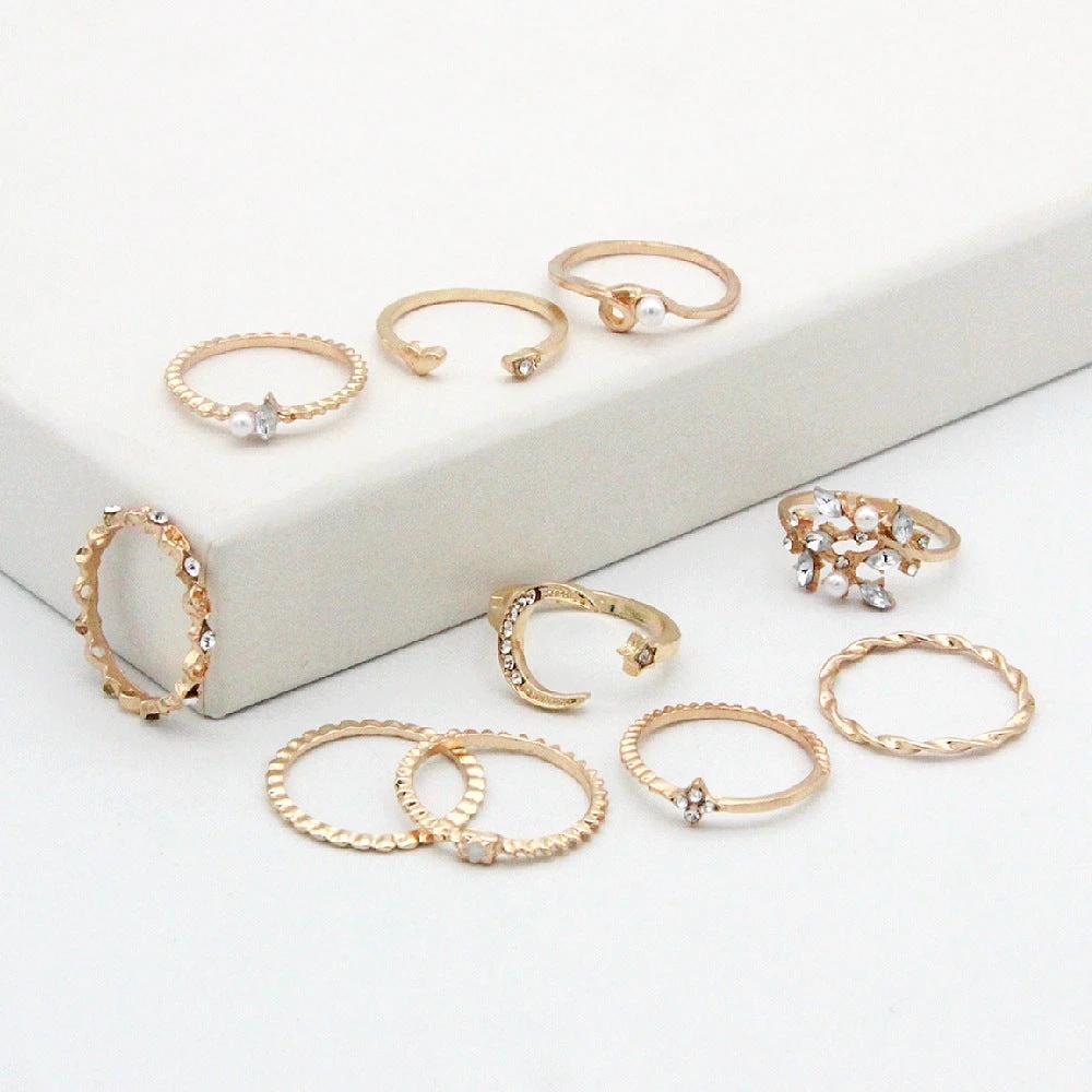 Mandotos 10-piece bohemian ring set with star, moon, pearl, and leaf designs in gold finish, stackable and stylish jewelry.