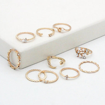 Mandotos 10-piece bohemian ring set with star, moon, pearl, and leaf designs in gold finish, stackable and stylish jewelry.