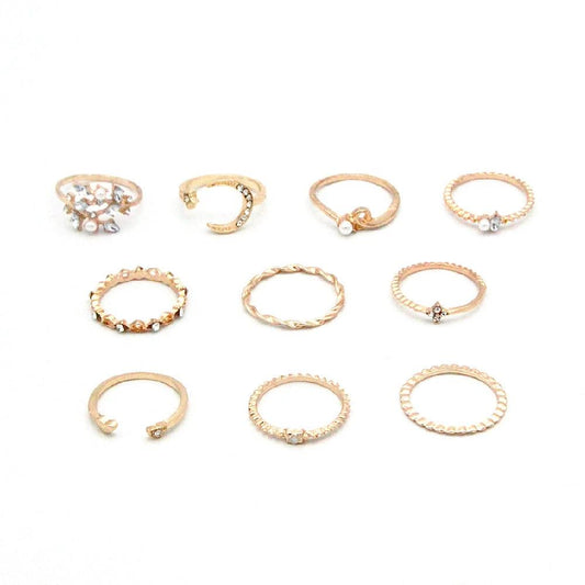 Mandotos bohemian star, moon, pearl, and leaf 10-piece gold finish ring set with stackable designs on a white background.