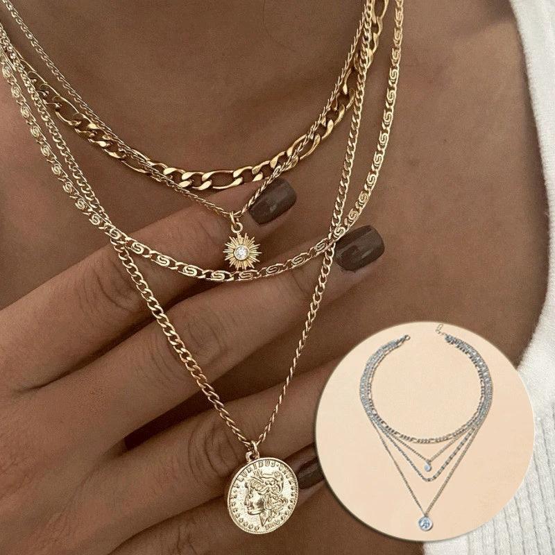 Mandotos gold layered necklace with coin pendant and sun charm, stylish jewelry for women featuring bold, chunky design.