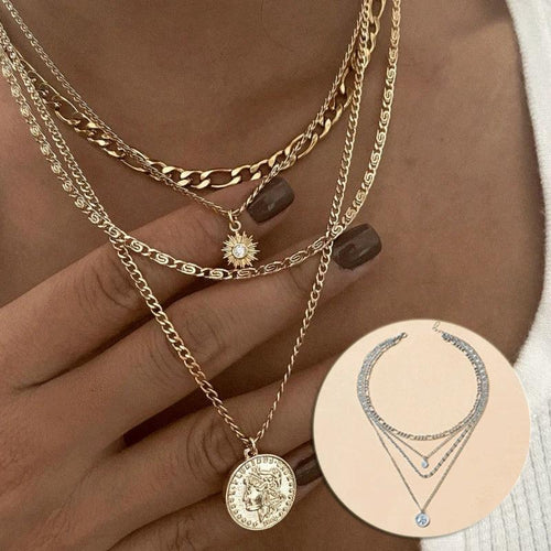 Mandotos gold layered necklace with coin pendant and sun charm, stylish jewelry for women featuring bold, chunky design.
