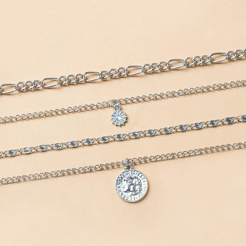 Mandotos chunky gold layered necklace featuring a coin pendant and sun charm for women, stylish jewelry accessory.
