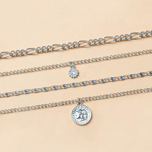 Mandotos chunky gold layered necklace featuring a coin pendant and sun charm for women, stylish jewelry accessory.