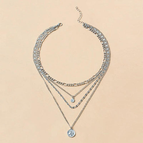 Mandotos chunky gold layered necklace featuring a coin pendant and sun charm for women, stylish jewelry accessory.