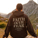 Unisex brown Christian hoodie by Mandotos featuring faith over fear message and Psalm 118:6 Bible verse design.