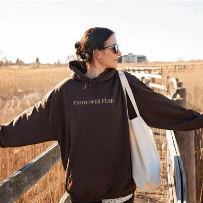 Unisex brown Christian hoodie by Mandotos with "Faith Over Fear" and Psalms 118:6 Bible verse printed on the front.