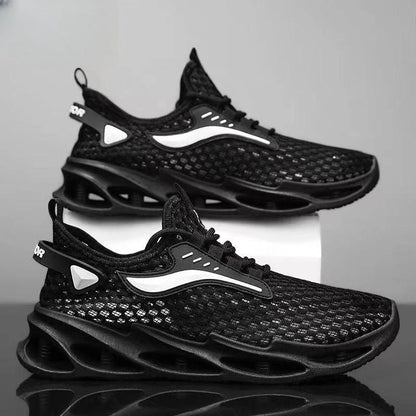 Men's black lace-up sneakers by MANDOTOS with mesh upper, hollow sole, and low-top design, suitable for running and sports activities.