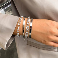 Mandotos C-shaped hollow chain bracelet set featuring simple, smooth design with multiple bracelets for a stylish look.