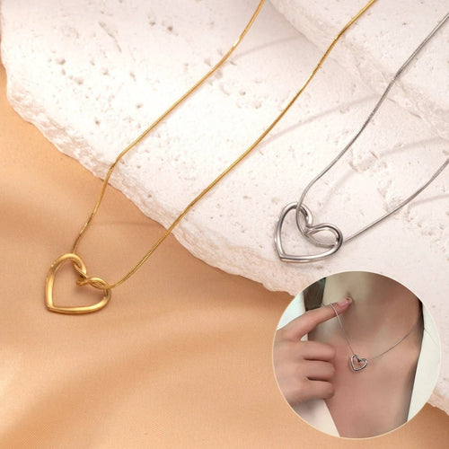 Stainless steel twist hollow heart necklace on a clavicle chain, featuring a sleek, modern design by MANDOTOS.
