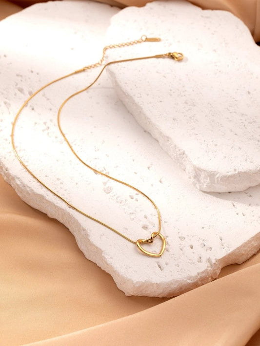 Stainless steel twist hollow heart necklace on a clavicle chain, featuring a delicate, modern design by MANDOTOS.