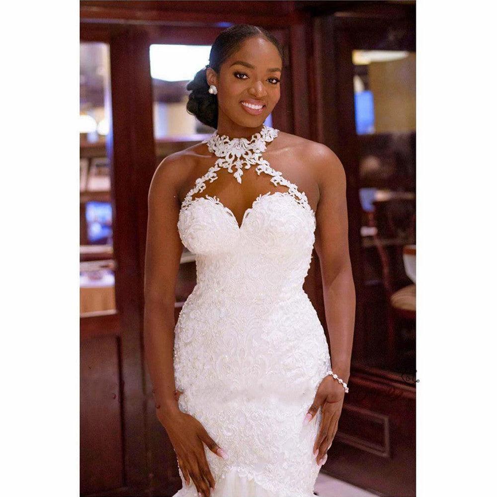 Mandotos vintage lace beaded mermaid wedding dress with sheer neckline, intricate beadwork, and elegant bridal gown design.