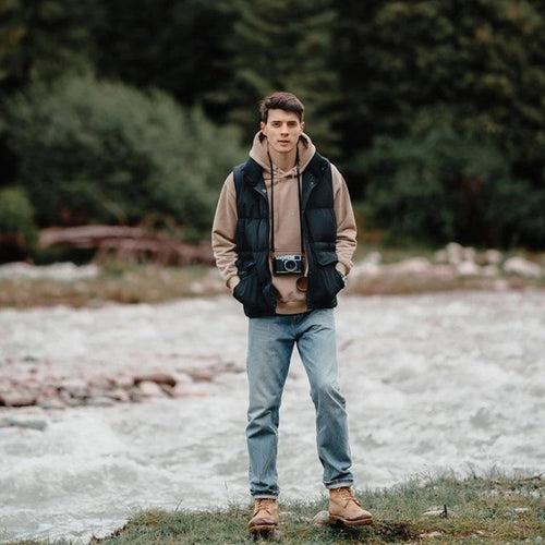 White duck down men's vest by MANDOTOS, insulated and weather-resistant, designed for warmth and durability in outdoor wear.