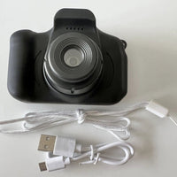 Mandotos X2 HD Mini Cartoon Kids Digital Camera showing colorful cartoon design and compact size for children.