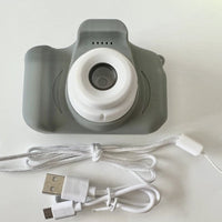 Mandotos X2 HD Mini Cartoon Kids Digital Camera showing colorful cartoon design and compact size for children.