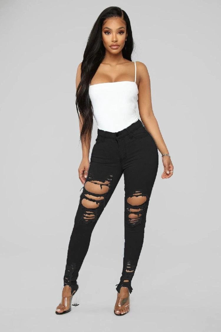 Mandotos denim pencil pants for women, slim fit, long trousers with ripped holes and stretch feet detail.