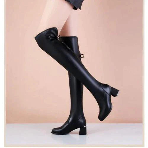 Elastic leather knee boots by MANDOTOS featuring a sleek design, fitted elastic sides, and sturdy heels for stylish comfort.
