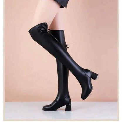 Elastic leather knee boots by MANDOTOS featuring a sleek design, fitted elastic sides, and sturdy heels for stylish comfort.