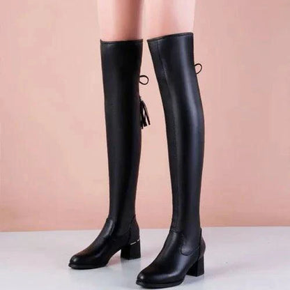 Elastic leather knee boots by MANDOTOS featuring a sleek design with a fitted silhouette and sturdy heel.