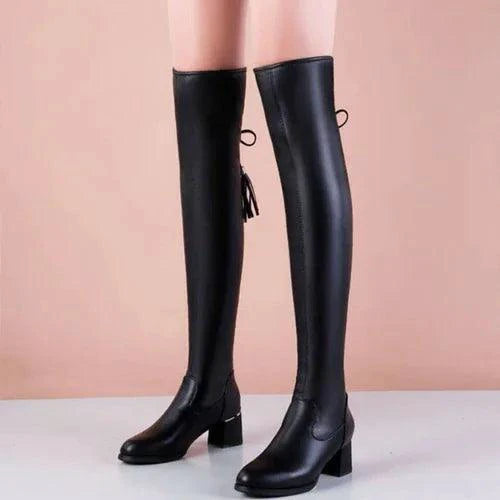 Elastic leather knee boots by MANDOTOS featuring a sleek design with a fitted silhouette and sturdy heel.