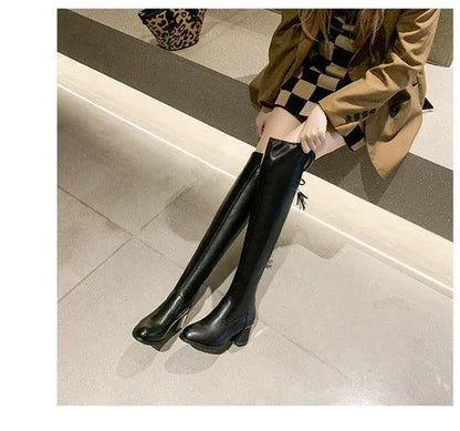 Elastic leather knee boots by MANDOTOS featuring a sleek design with stretch panels and sturdy heels.