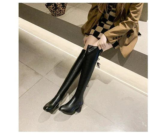 Elastic leather knee boots by MANDOTOS featuring a sleek design with stretch panels and sturdy heels.