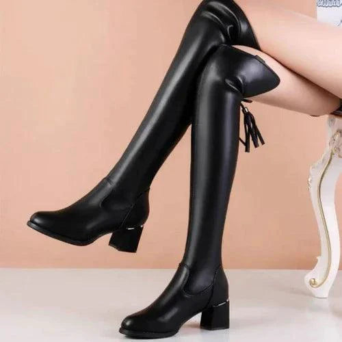 Elastic leather knee boots by MANDOTOS featuring a sleek design, pointed toe, and low block heel for stylish comfort.
