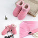 Mandotos electric heated shoes with glowing heating elements and black exterior, designed for warmth and comfort.