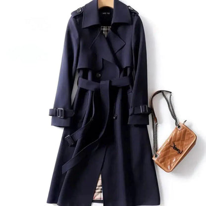 Mandotos elegant classic trench coat displayed on a hanger, showcasing its tailored design and neutral color for a timeless look.