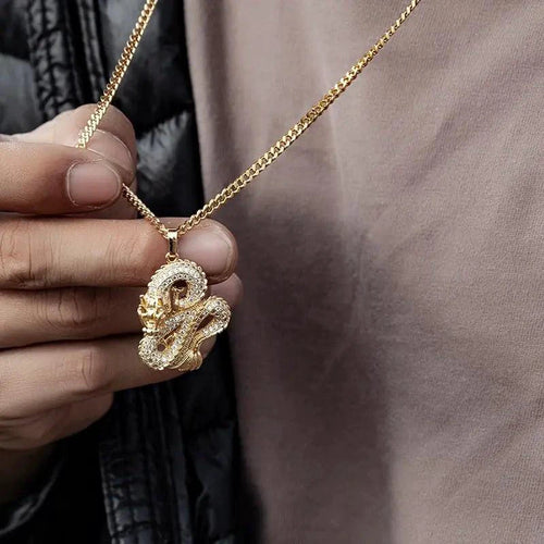 Elegant gold zircon dragon pendant from MANDOTOS featuring intricate design and sparkling gemstones on a chain.