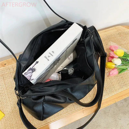 Elegant leather carryall handbag by MANDOTOS featuring a sleek design and durable leather construction.