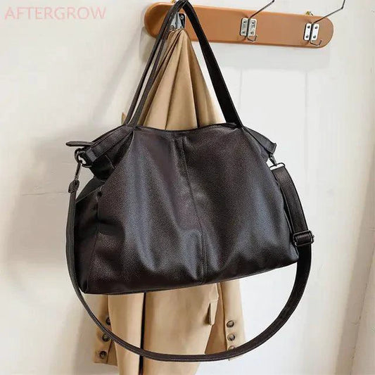 Elegant MANDOTOS leather carryall bag with structured design and sturdy handles, perfect for stylish everyday use.